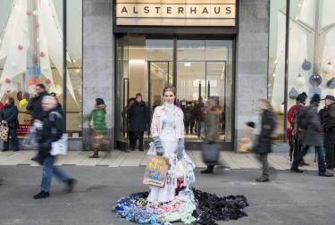 An activist disguised as a Trash Queen promotes “Buy Nothing Day” on Black Friday in Hamburg, Germany, 2016, as part of a Greenpeace campaign to reduce overconsumption.